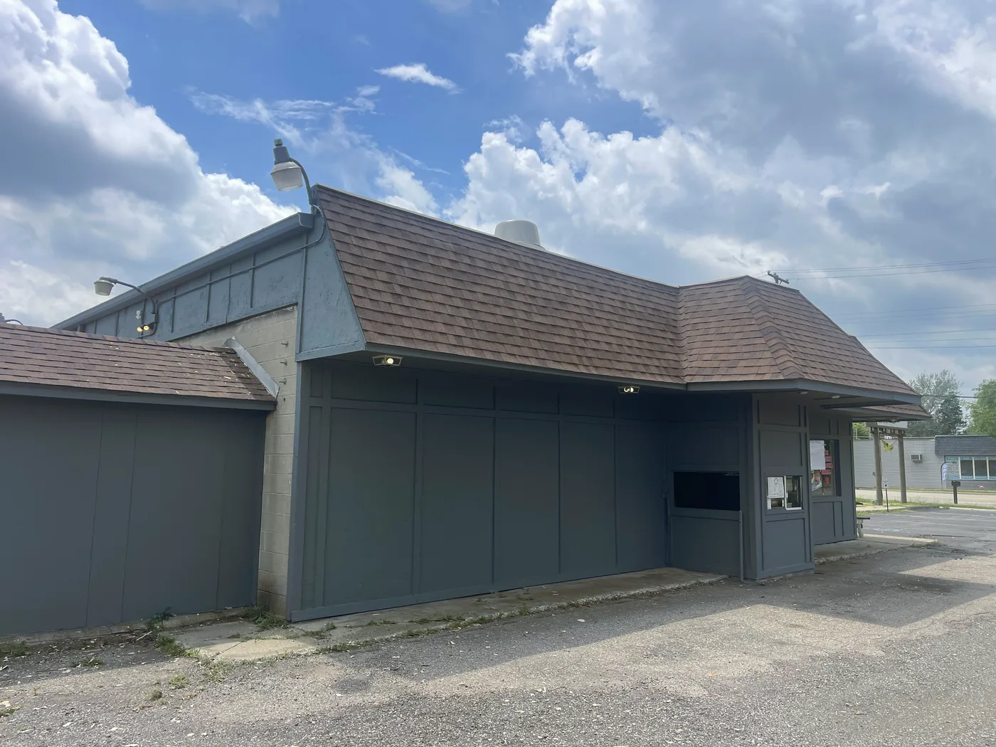 A low commercial building painted a single slate gray.